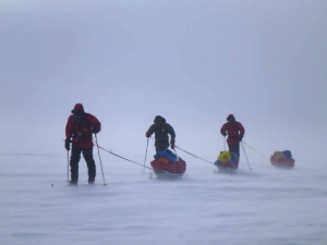 Three skiers agains the wind on the Ross Ice Shelf.