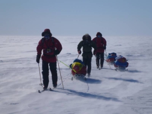 Three skiers in headwind at the Ross ice shelf.